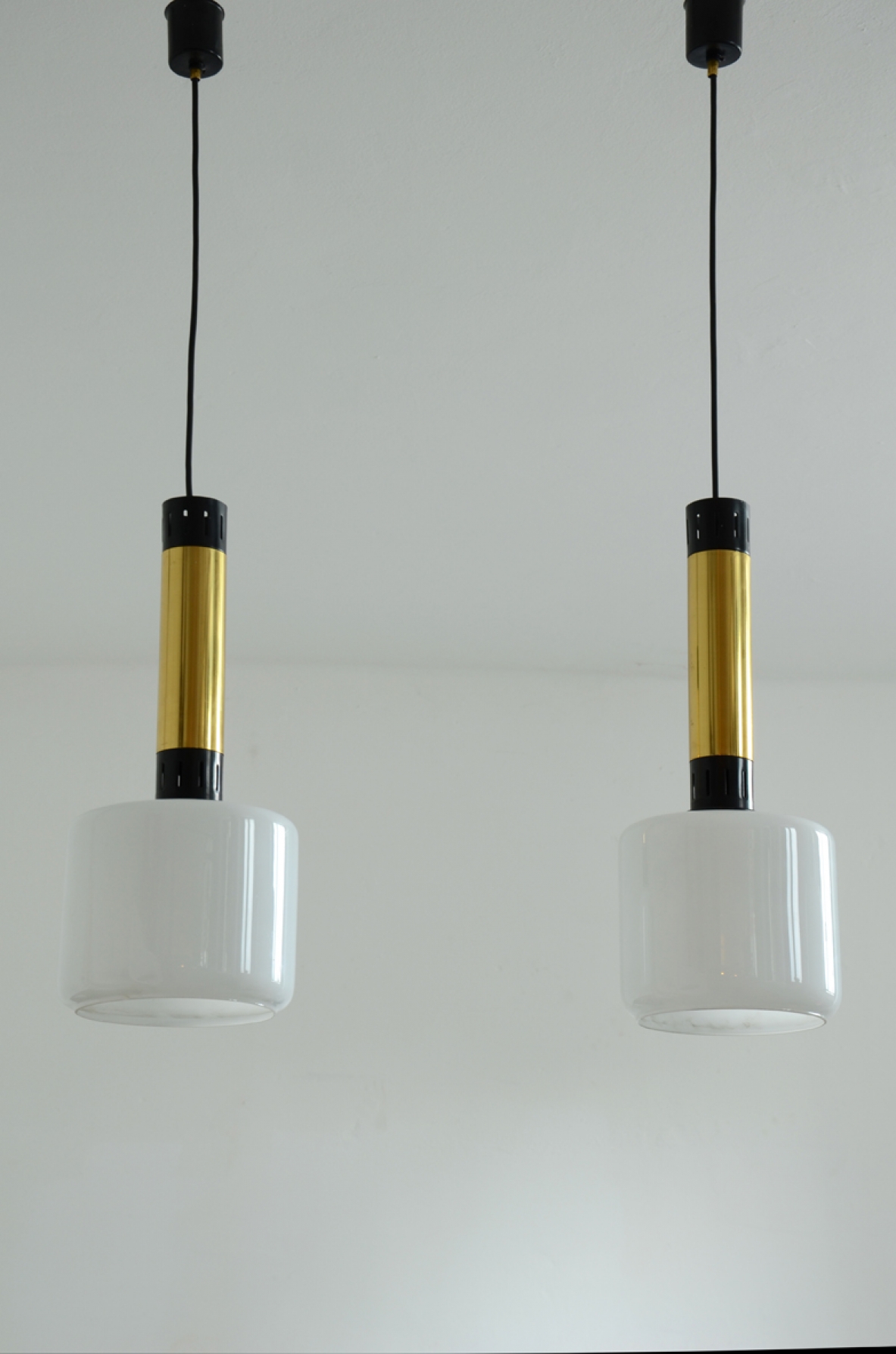 Three elegant 1960’s Stilnovo ceiling lamps in brass and polished metal with a nice and big opal glass shade.  Prod. Stilnovo, Milano.