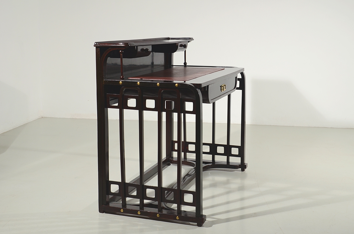 Josef Hoffman, rare desk designed in 1905 ca. and manufactured by J.& J. Khon, Vienna. Beech stained to simulate mahogany, top with a dark red leather, brass handle and details. Lit.: Kohn factory catalogue, 1906, p. 58.  