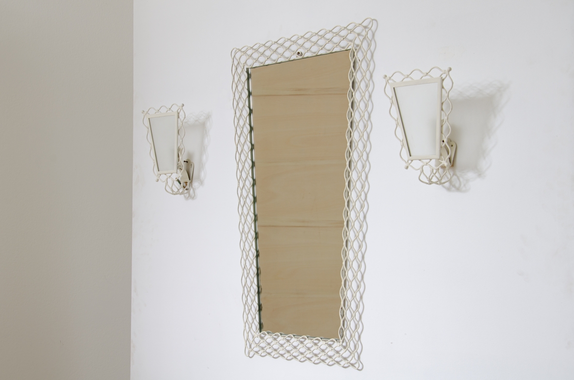Mirror with curved metal mesh frame with two wall lights of the same workmanship with satin glass.  Italy 1950s.