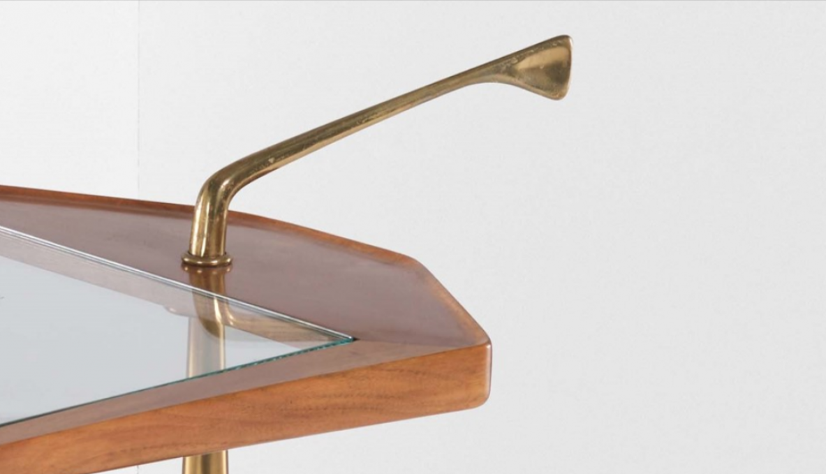 Service table on wheels with two wooden and glass tops. Side upright in shaped brass.  Italian manufacture from the 1950s.
