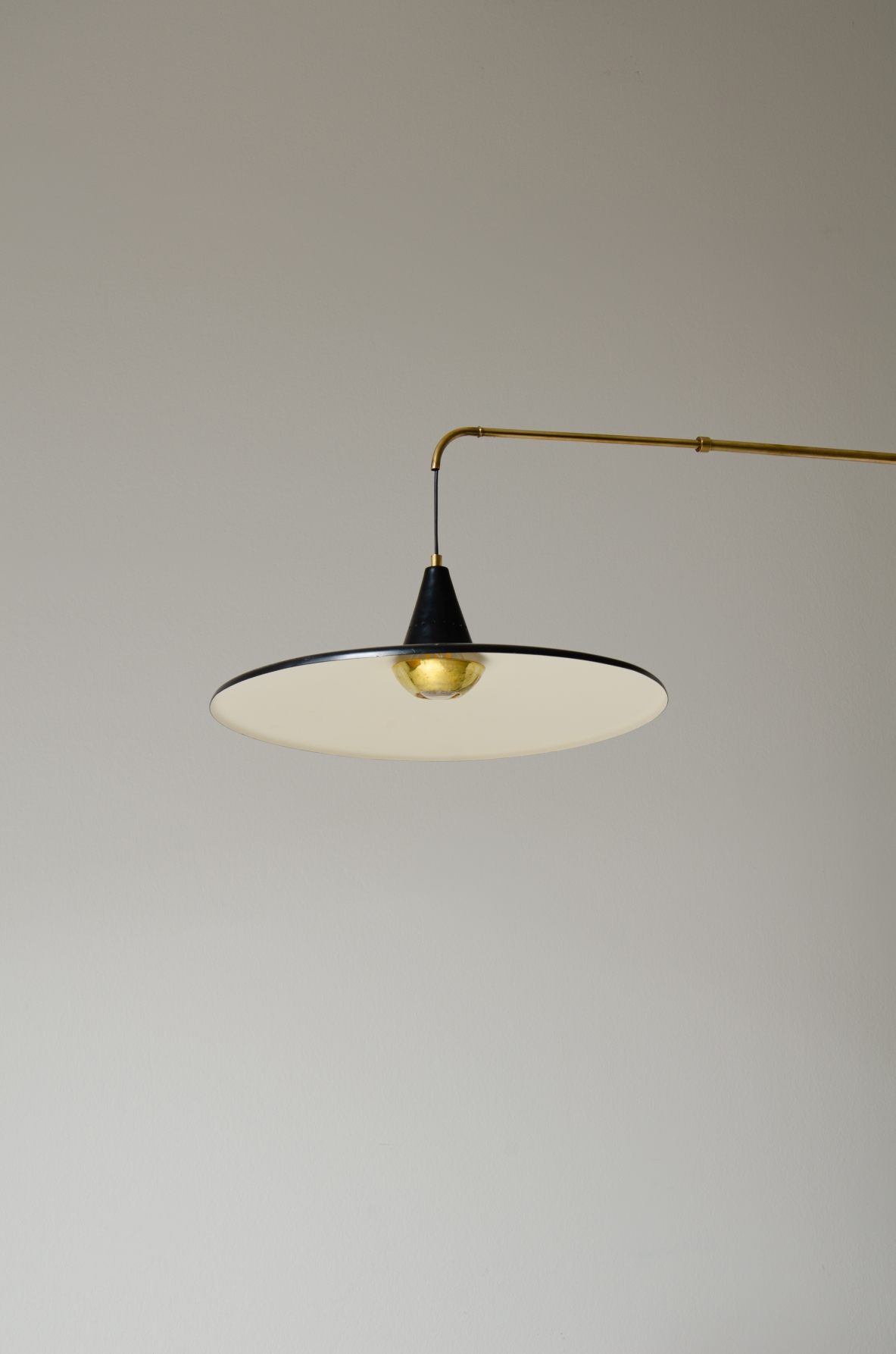 Extensible lamp with with brass stem and black painted metal shade.  Italian manufacture, 1950s.