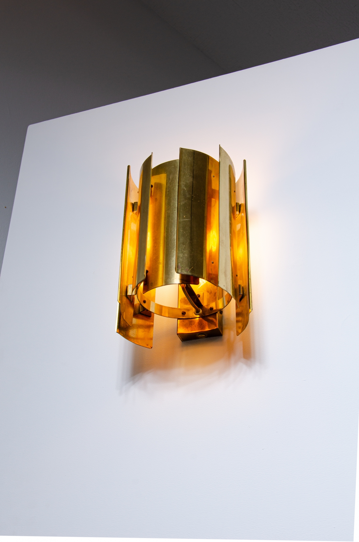 Pair of Scandinavian wall lights in curved brass.  Prod. Falknbergs, Sweden 1960's.