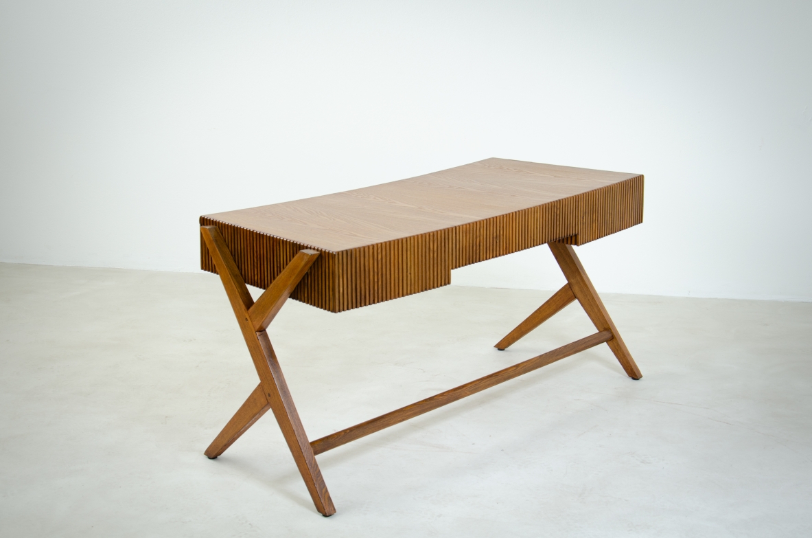 Oak desk with three drawers with ribbed wood band and curved top supported by double Y legs.  Turin School, Italy, 1950's.