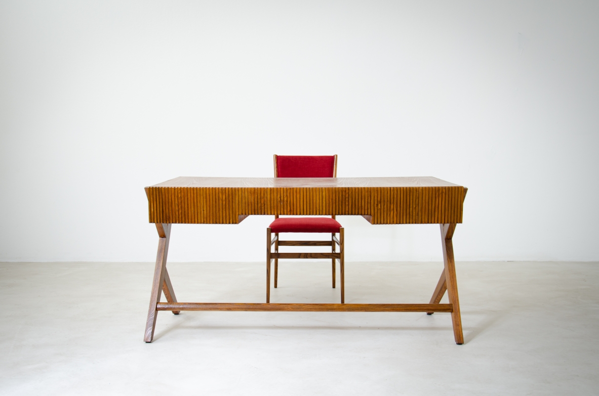 Oak desk with three drawers with ribbed wood band and curved top supported by double Y legs.  Turin School, Italy, 1950's.