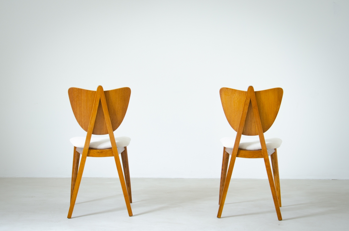 Two oak chairs with padded wooden seat and heart-shaped back.  French manufacture, 1950's.