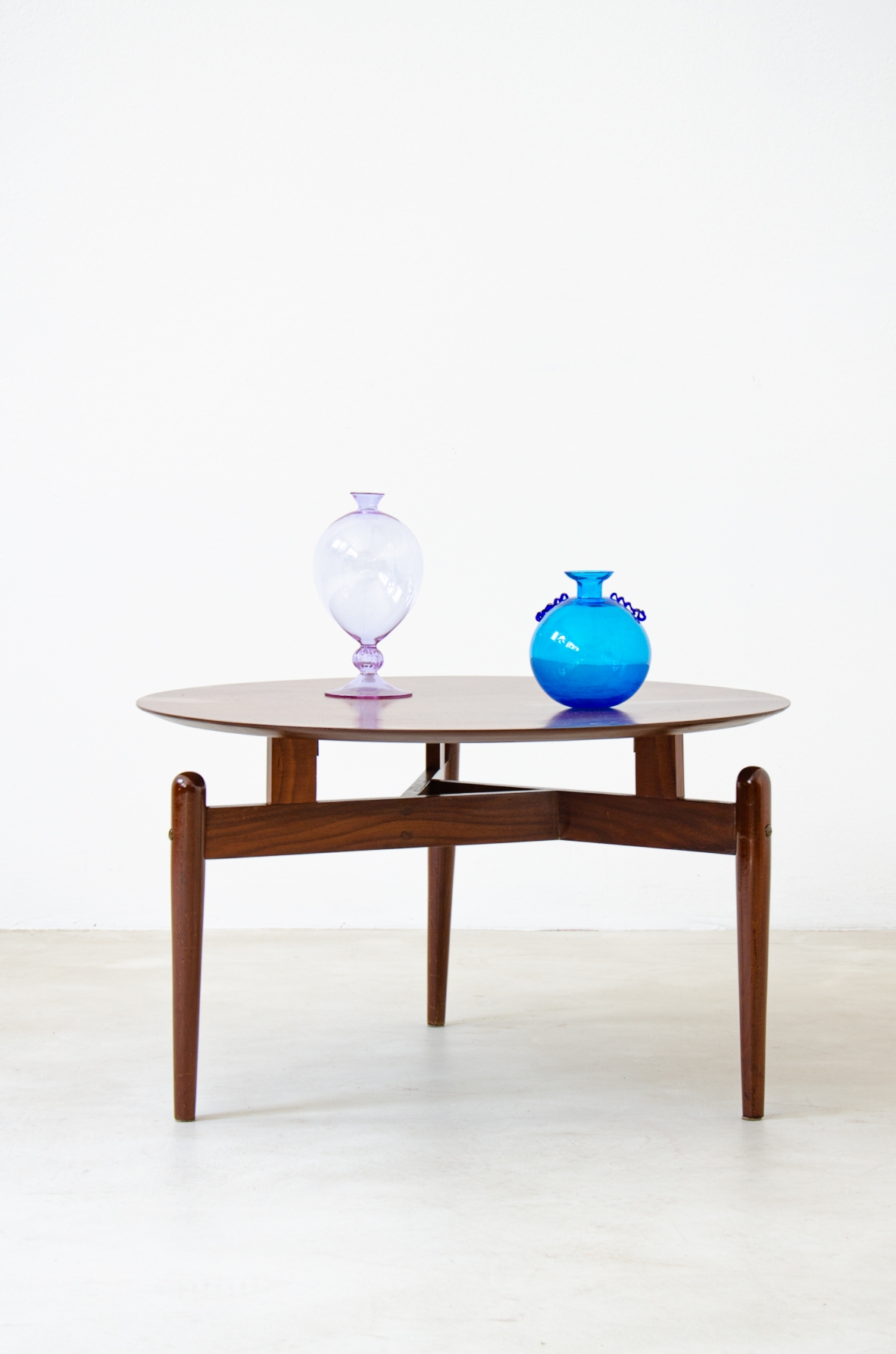 Teak coffee table with three legs held by a structure with crossed spokes and suspended top.  1960's Italian manufacture.