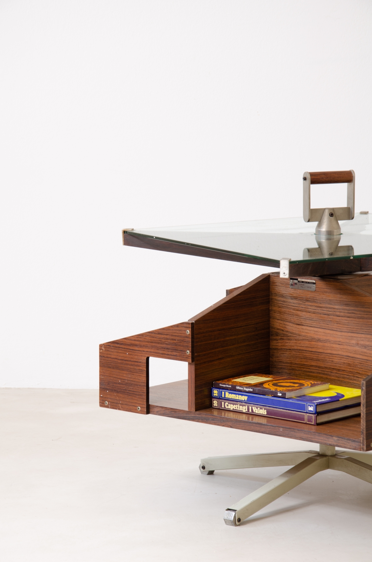Ico Parisi (1916-1996)  Low table in walnut with swivel shaped structure and swivel glass top with steel and wood handle.1958
