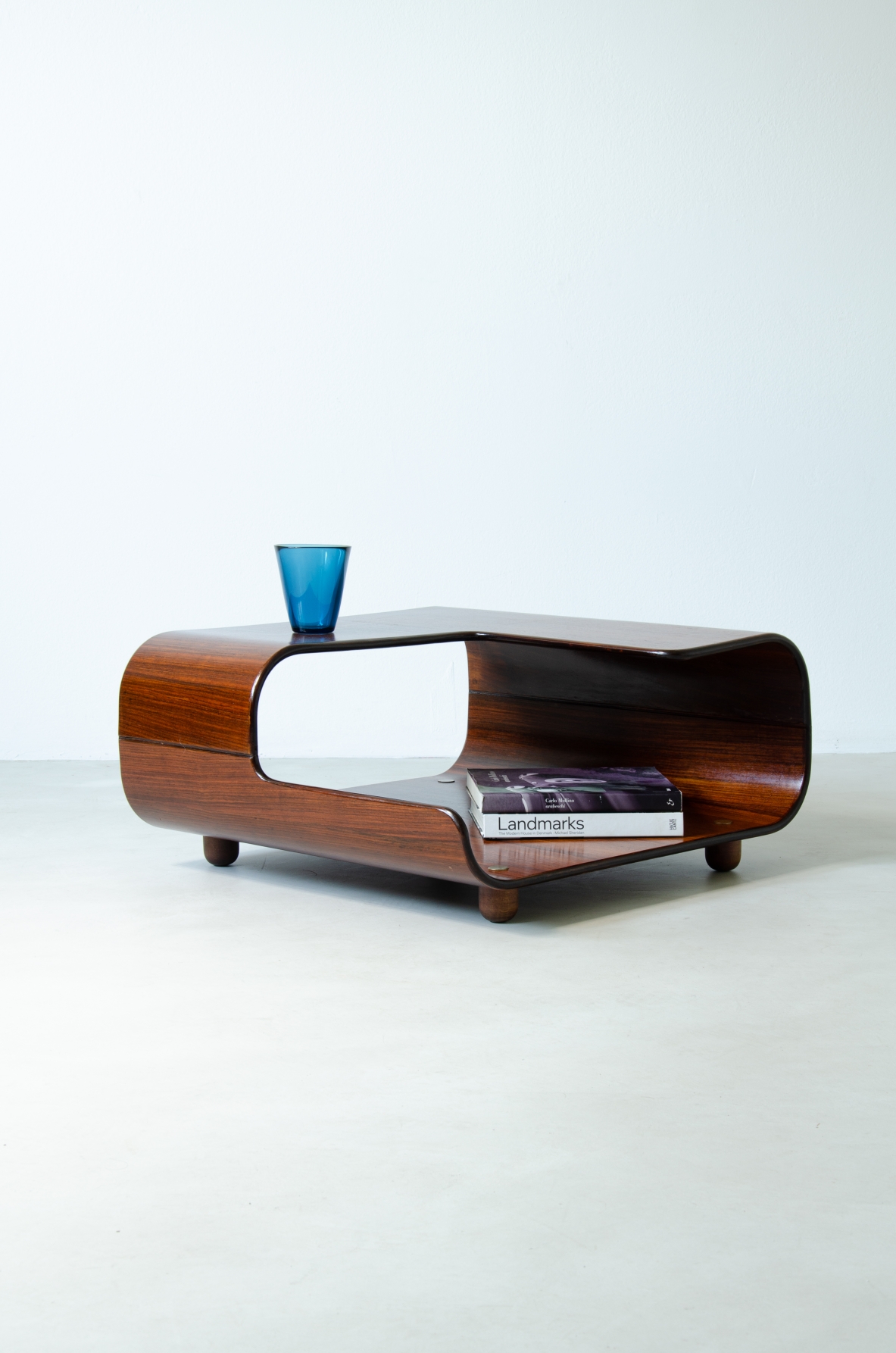 Coffee table in curved wood with two shaped shelves.  Italian manufacture, 1960's.