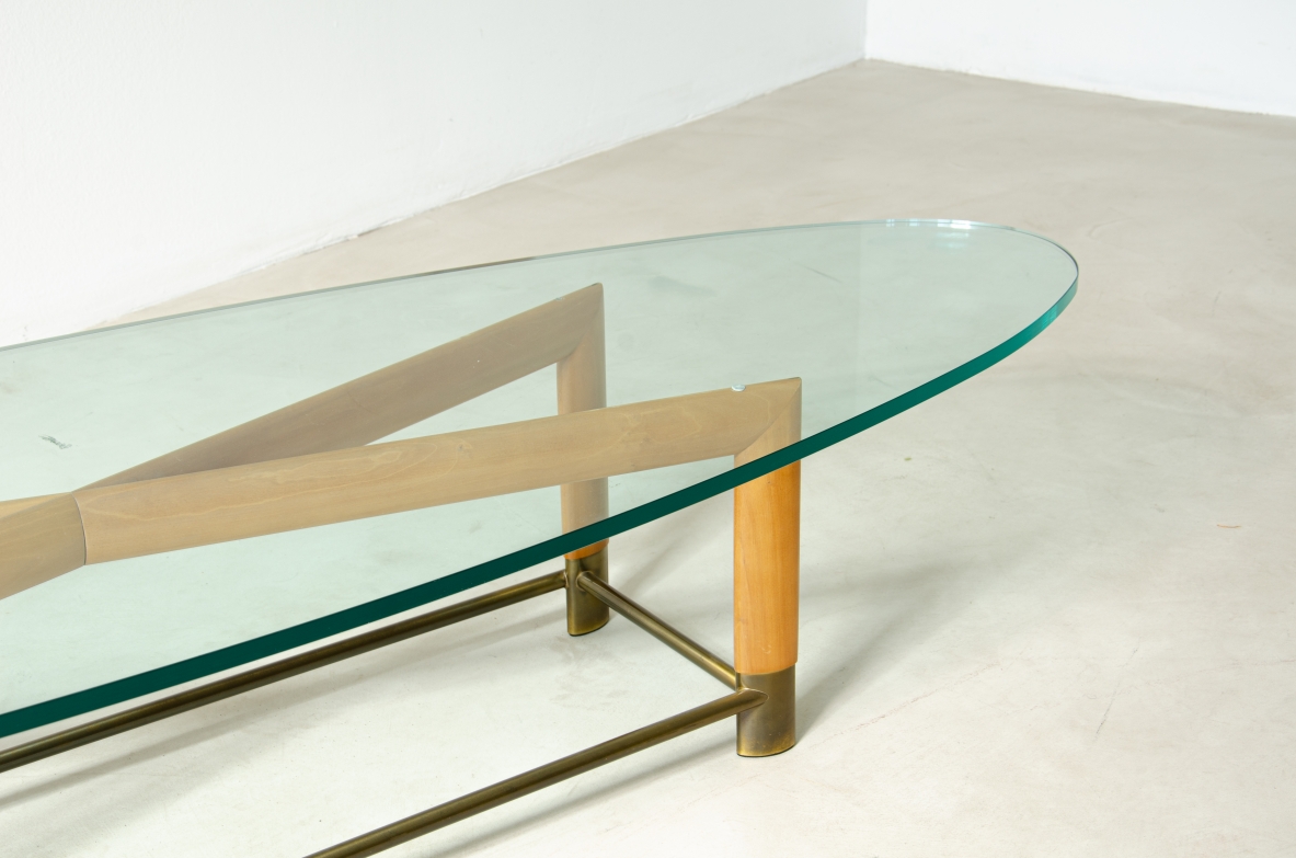 Tavolino ovale con struttura in legno, piedini in ottone e piano in cristallo molato. Manifattura italiana, 1950ca.