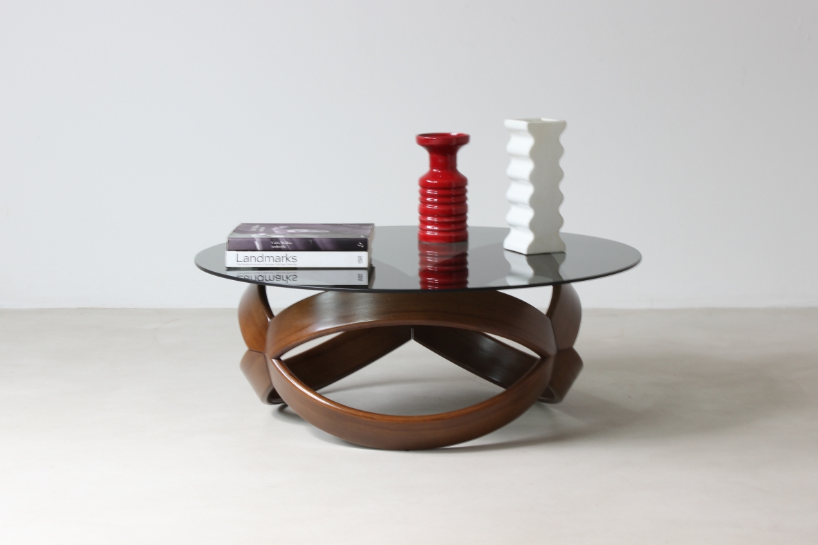 Low table with curved wooden base. Italian manufacture, 1970's.