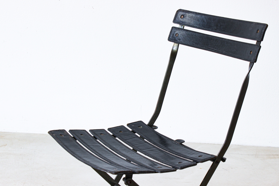 Folding chair in iron with upholstered in black leather. Italian manufacture, 1970's.