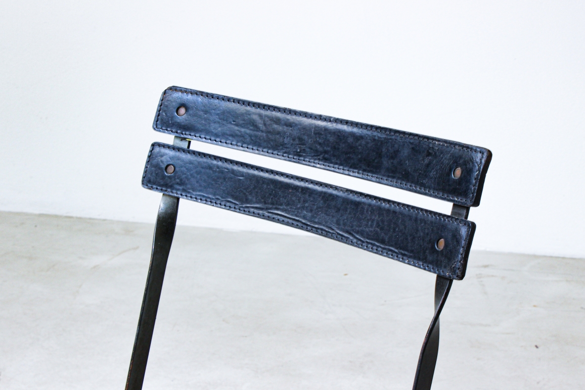 Folding chair in iron with upholstered in black leather. Italian manufacture, 1970's.