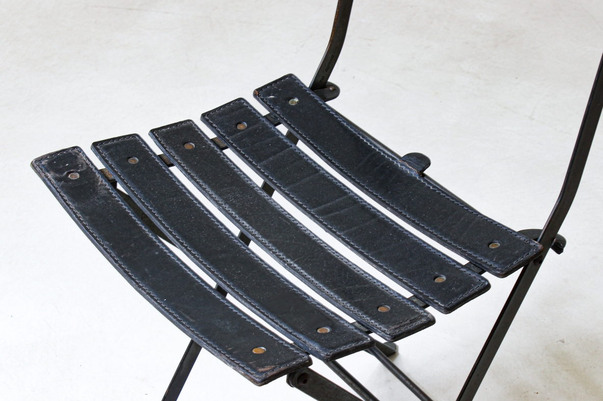 Folding chair in iron with upholstered in black leather. Italian manufacture, 1970's.