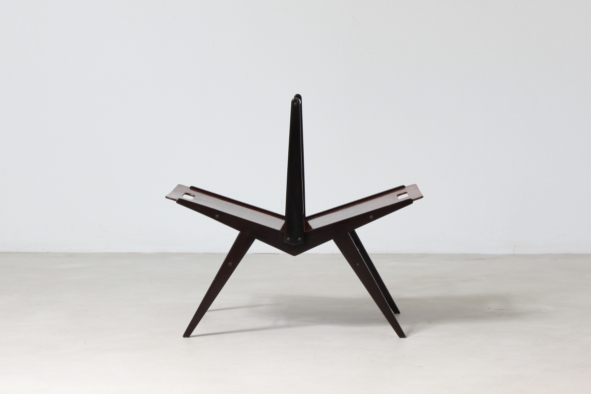 Elegant magazine rack in dark wood.  Italian manufacture, 1950's..