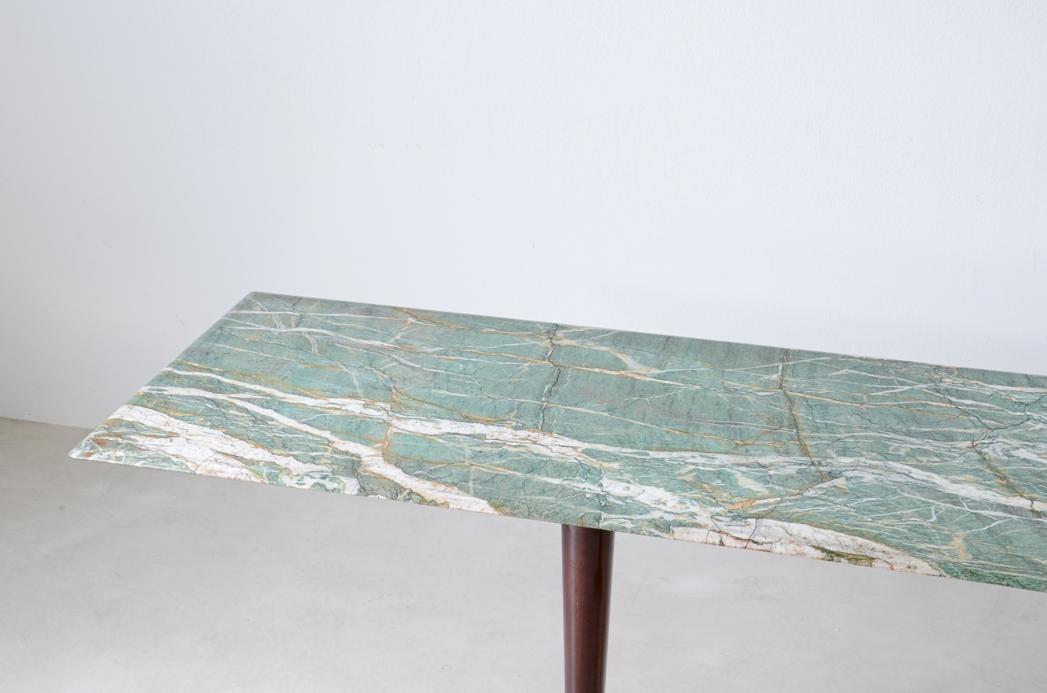 Guglielmo Ulrich. Raro tavolo console con piano in marmo sagomato, tre montanti in legno con piedi e catena in bronzo e ottone.