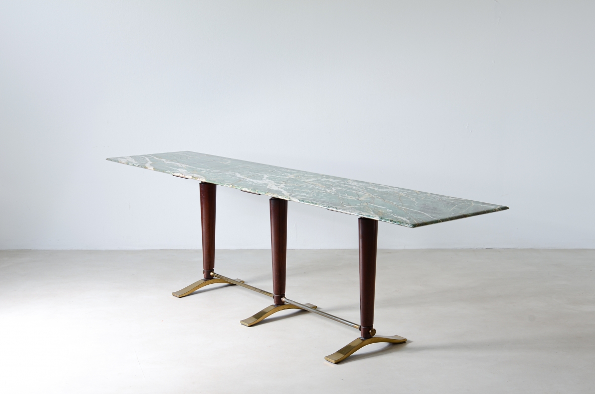Guglielmo Ulrich. Raro tavolo console con piano in marmo sagomato, tre montanti in legno con piedi e catena in bronzo e ottone.