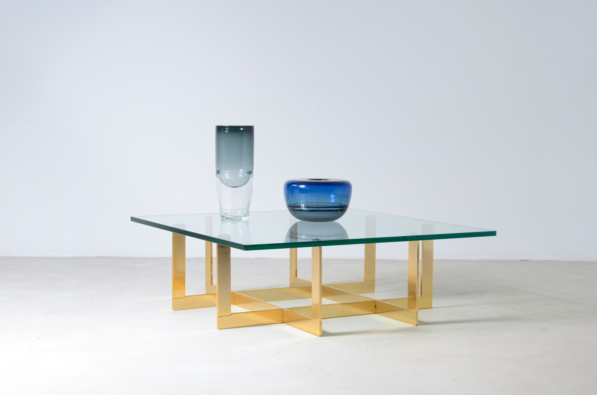 Elegant low table with brass structure and thick moulded crystal glass top.  Italian manufacture, around 1970.