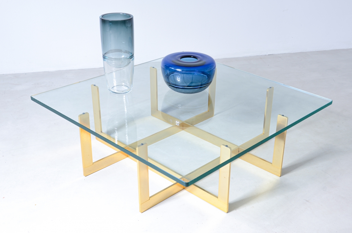 Elegant low table with brass structure and thick moulded crystal glass top.  Italian manufacture, around 1970.