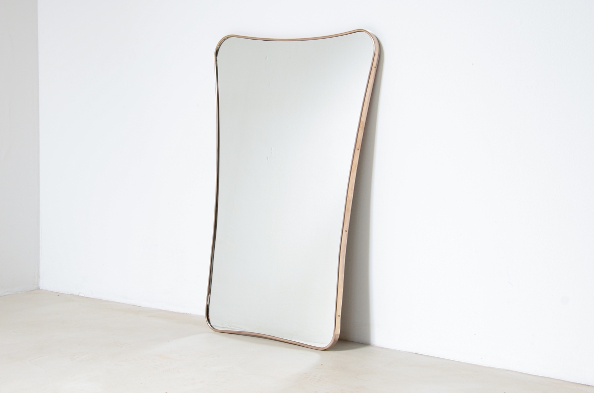 Elegant mirror  with shaped brass frame. Italian manufacture, 1950's.