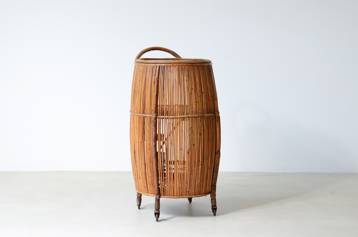 Bar cabinet in rattan and woven staraw, wooden top and compartments for bottles and glasses.  Italian manufacture, around 1950.