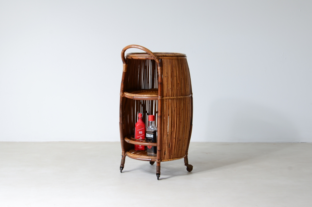Bar cabinet in rattan and woven staraw, wooden top and compartments for bottles and glasses.  Italian manufacture, around 1950.