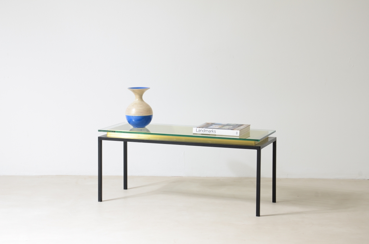 Low table with metal structure, brass riser and thick cut glass top.  Italian manufacture around 1960.