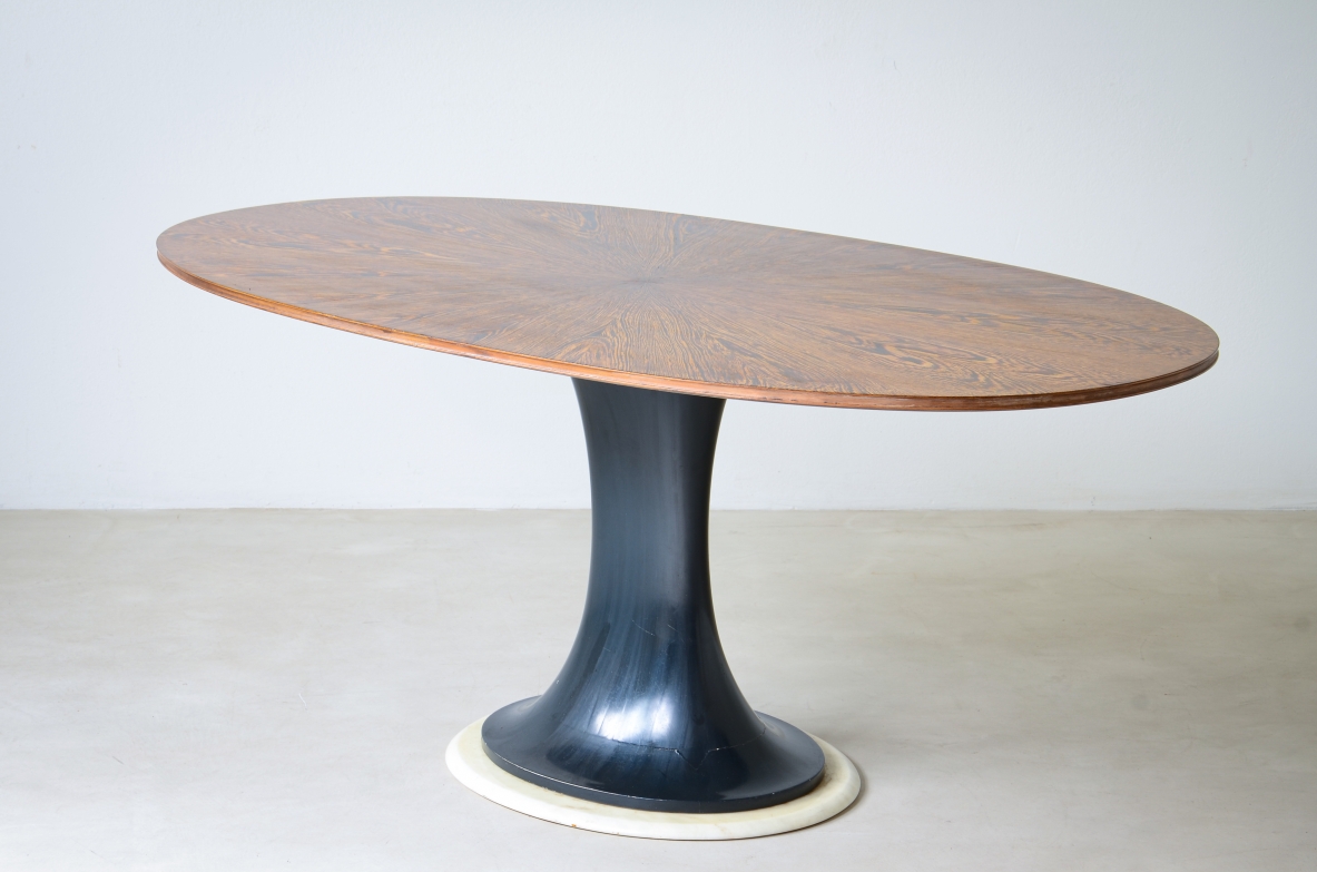 Elegant oval table with turned base in petrol blue lacquered wood and marble disc.  Palm wood veneer top.  Turin School, 1960's.
