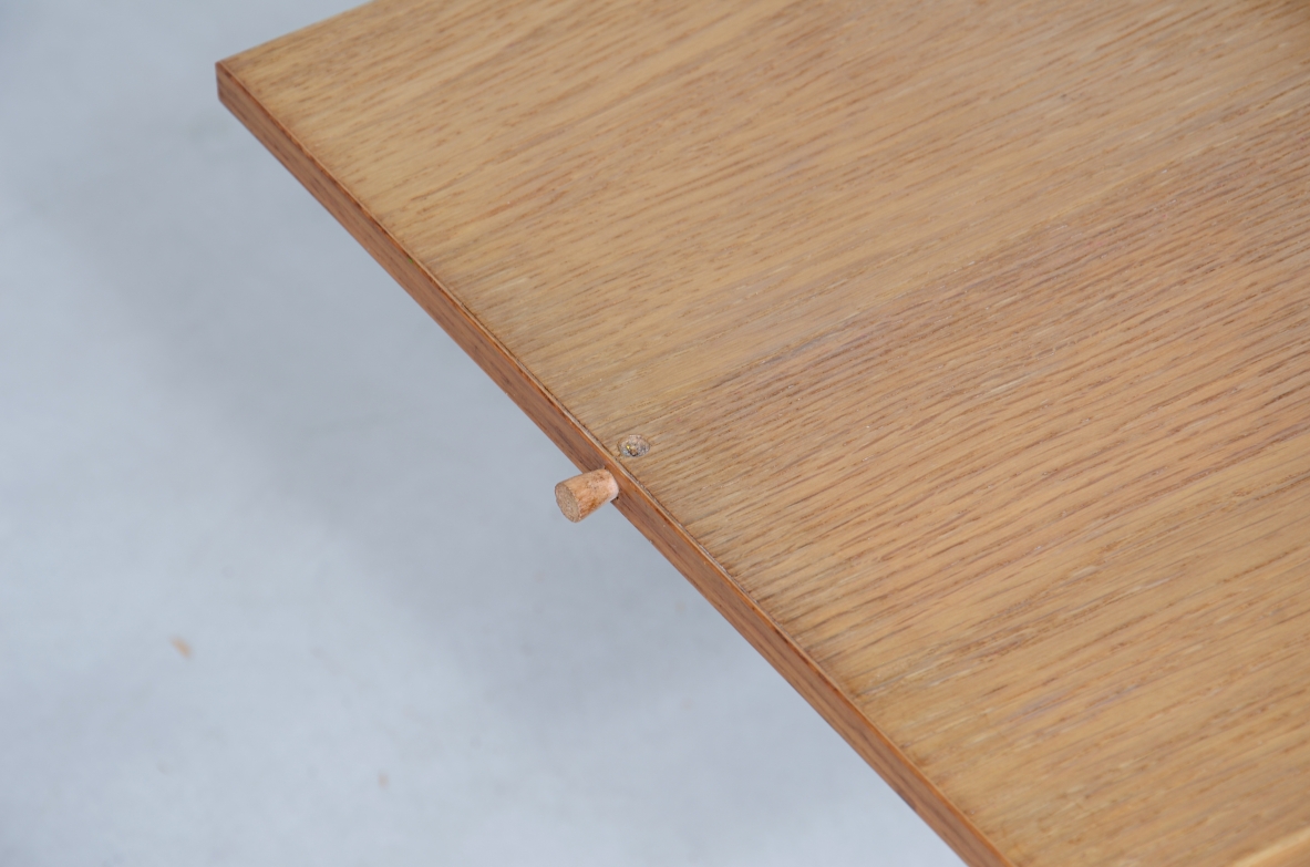 Low table with wooden and slate top, one compartment under the central wooden top and two side shelves.  Italian manufacture around 1960s.