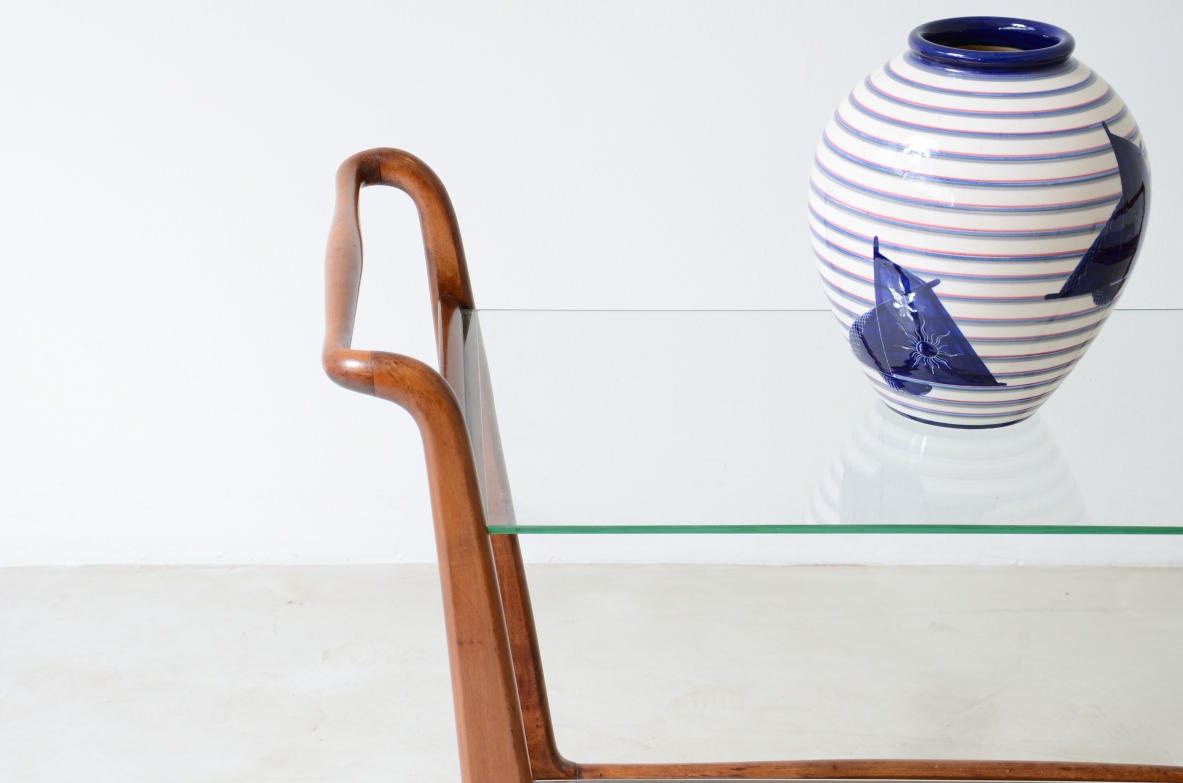 Walnut wood trolley with glass tops and wheels in the style of Gio Ponti.  Italy, 1950