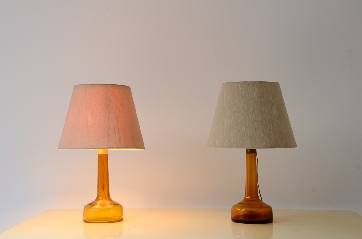Pair of colored glass lamps with brass detail and fabric shade with perplexed disc.