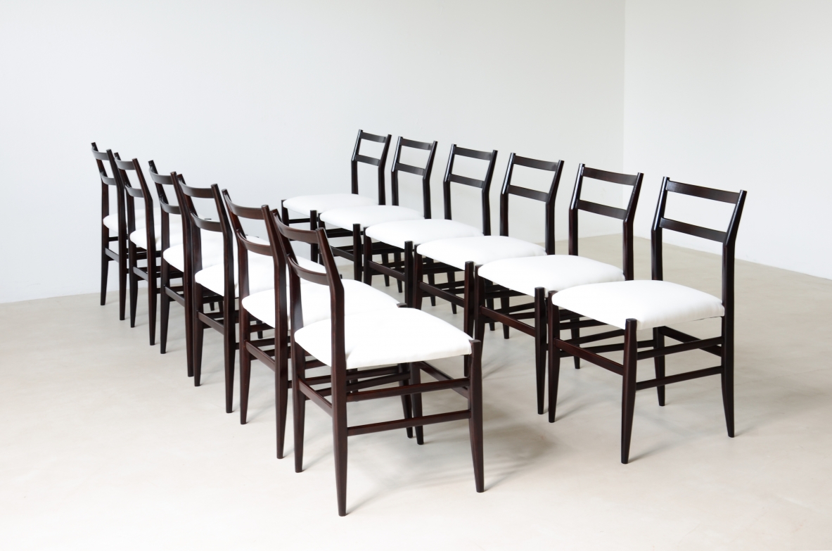 Gio Ponti  Set of 12 chairs in black stained wood with fabric covering.  Modello leggera,  Cassina manufacture 1954.