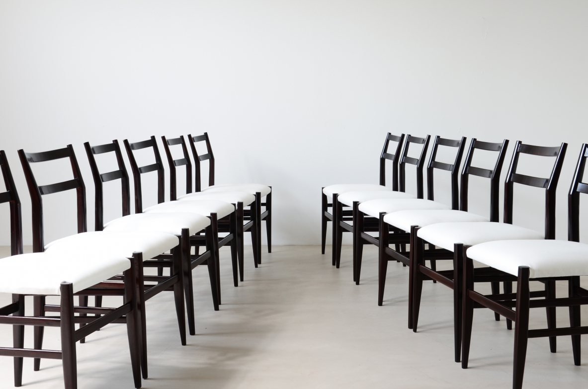 Gio Ponti  Set of 12 chairs in black stained wood with fabric covering.  Modello leggera,  Cassina manufacture 1954.