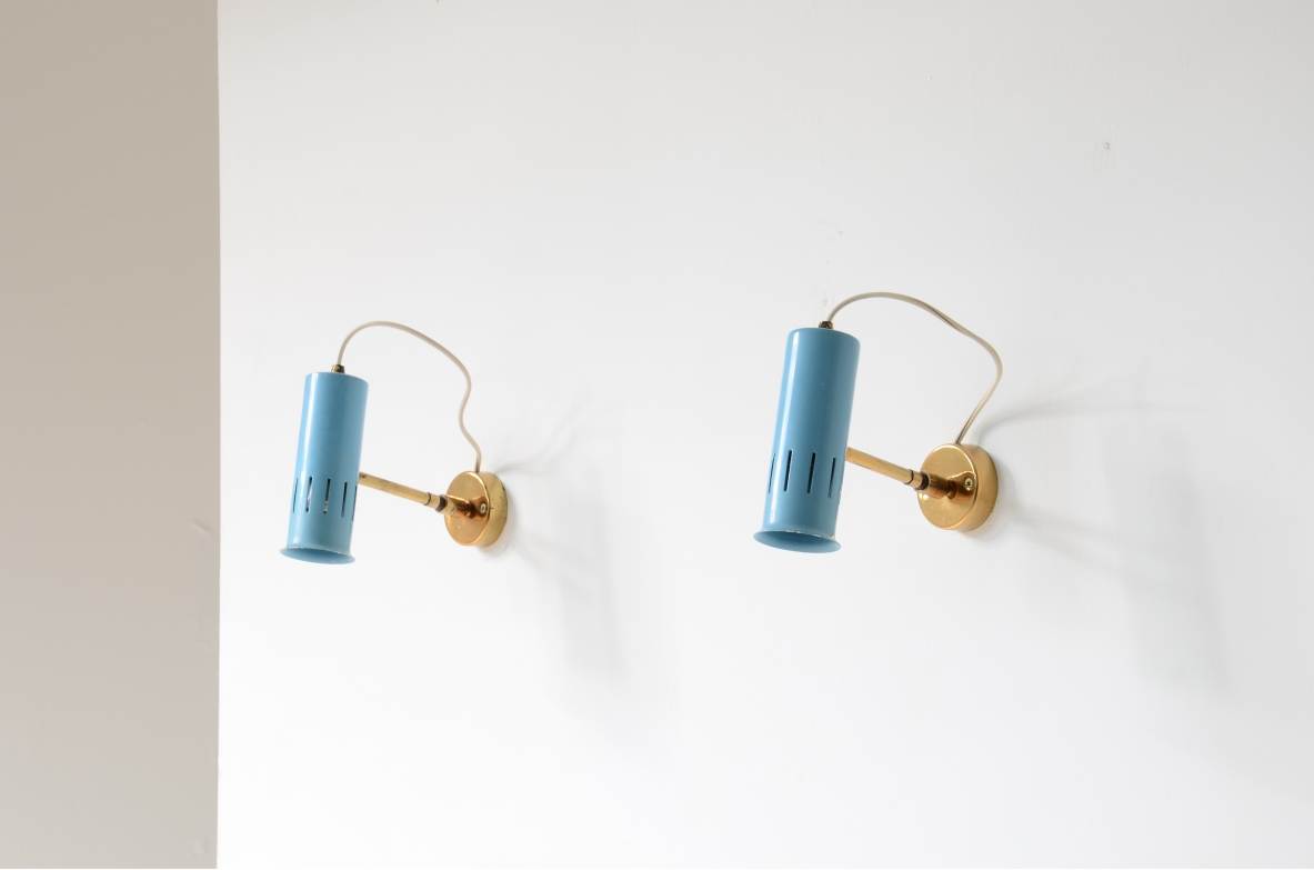 Pair of adjustable spotlights in all directions in lacquered metal and brass.1950