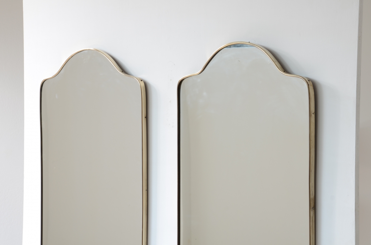 Pair of mirrors with shaped brass frame.  Italian manufacture, 1950s.