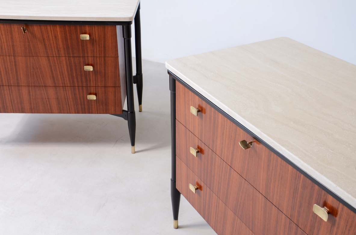elegant walnut cabinets with travertine tops, three drawers with shaped brass handles. Italian manufacture, circa 1955.