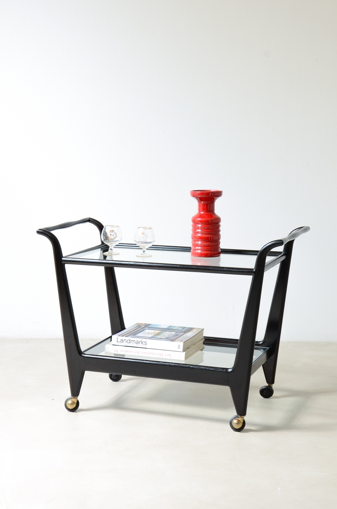 Stained wood serving trolley with two cut glass shelves.  Italian manufacture, ca. 1950.